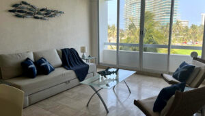 Interior de departamento Kabah 507: vista lateral de sala y ventanal, Vidanta, Acapulco, Guerrero, México